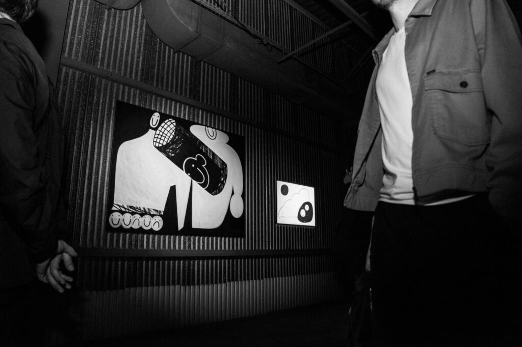 Contemporary art photography by Łukasz Zając, black and white shot of abstract graphic art displayed on a wall in a gallery, Kraków, Poland