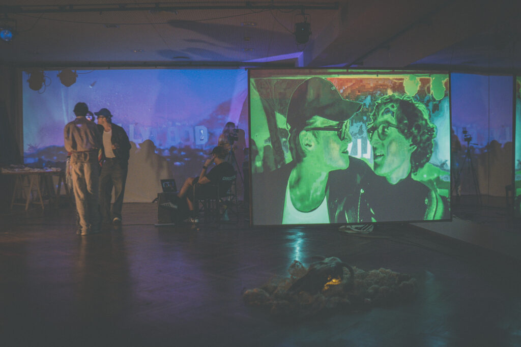 Contemporary art exhibition photography by Łukasz Zając, wide view of a video projection displayed on a screen in a gallery space, Poland