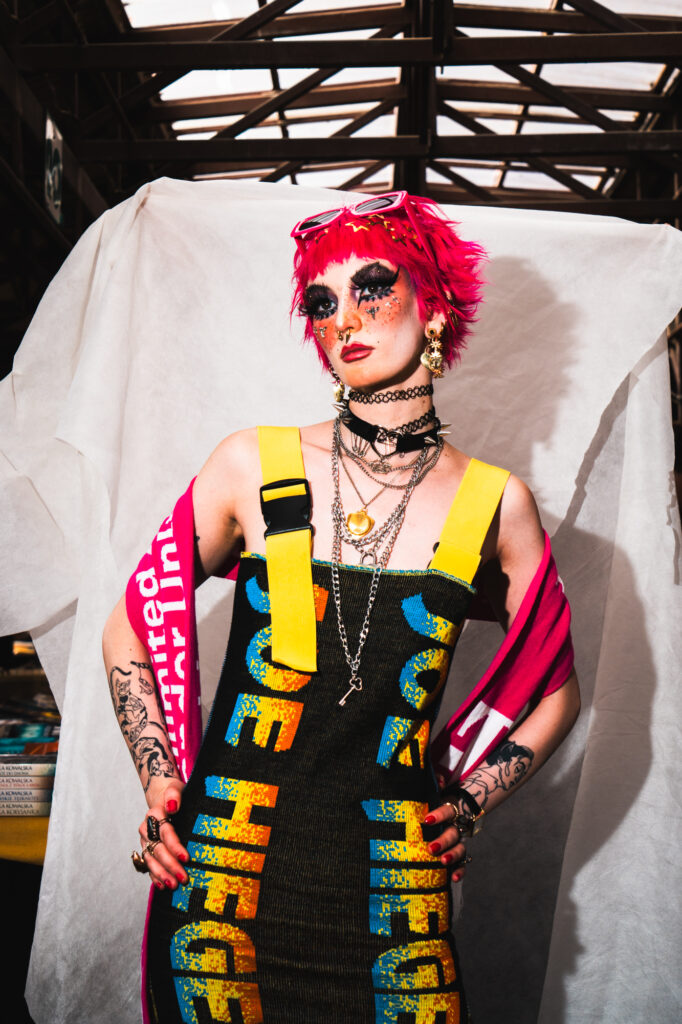 Editorial fashion campaign photography by Łukasz Zając, model with pink hair in bold graphic streetwear dress, Krakow, Poland