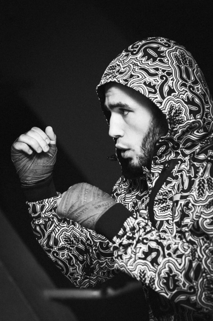 Portrait photography by Łukasz Zając, black and white side profile of a person wearing a patterned hoodie, Poland