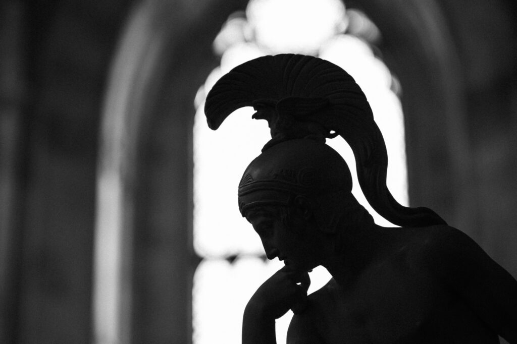 Fine art and architectural photography by Łukasz Zając, close-up monochrome shot of a classical statue wearing a crested helmet, Kraków, Poland