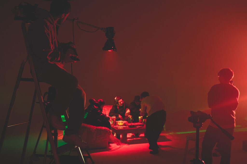 Commercial photography behind-the-scenes by Łukasz Zając, photo shoot setup with crew and red and green lighting in a studio, Kraków, Poland
