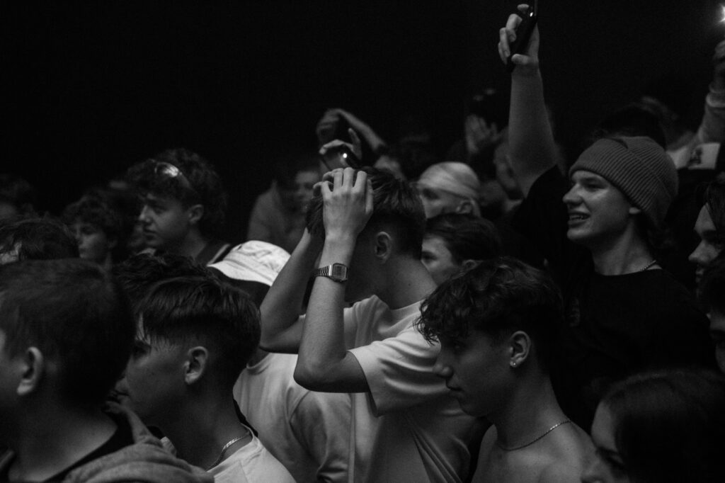 Culture and events concert photography by Łukasz Zając, black and white crowd shot watching a performance, Poland