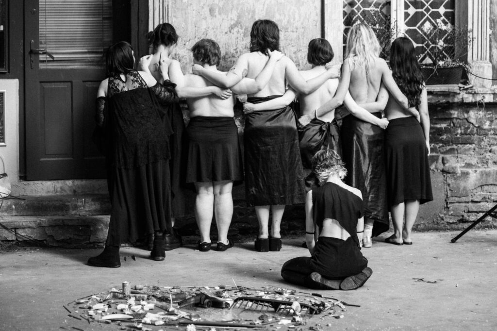 Artistic and event photography by Łukasz Zając, black and white group photo of people standing in a row in historical attire, Poland